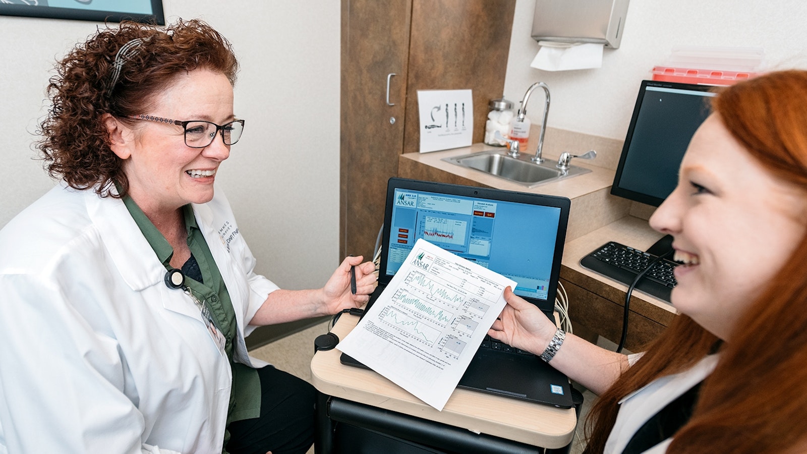 Dr. Debbie Turner and Kelli Patrick discussing a patient document