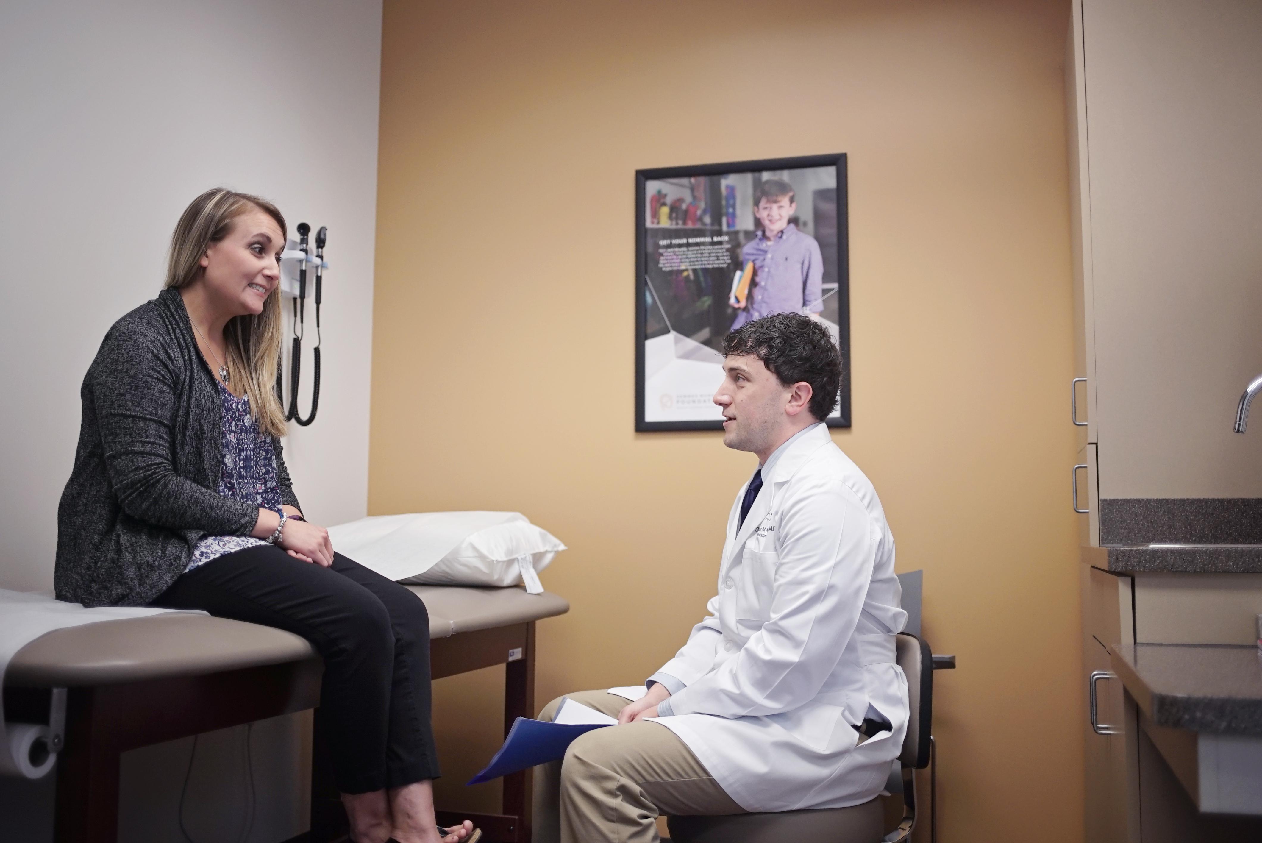 Dr. Chris Nickele sitting with a patient at Semmes Murphey
