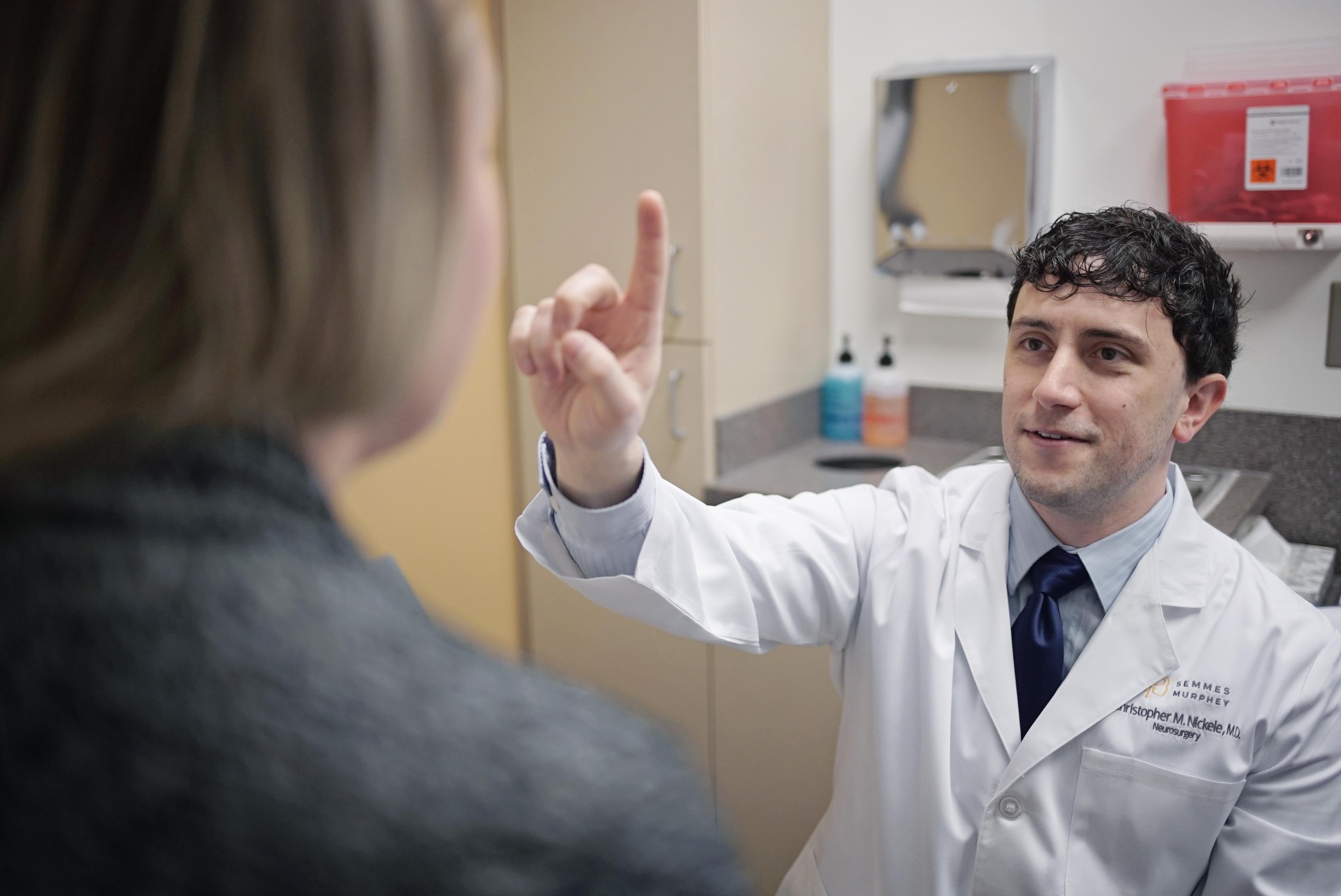Doctor Nickele performs an eye exam on patient