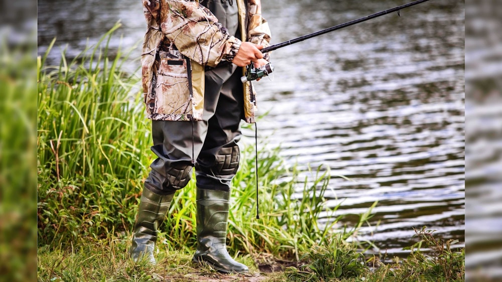Man standing fishing 16 9