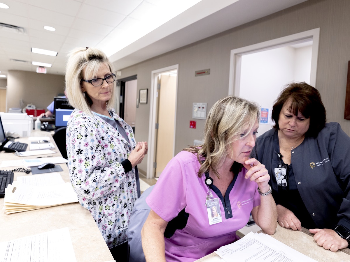 Nurses working on computer in surgery center at Semmes Murphey