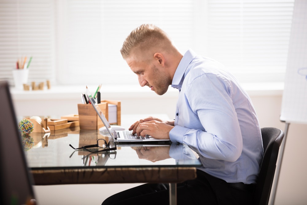 Man slouching at desk small